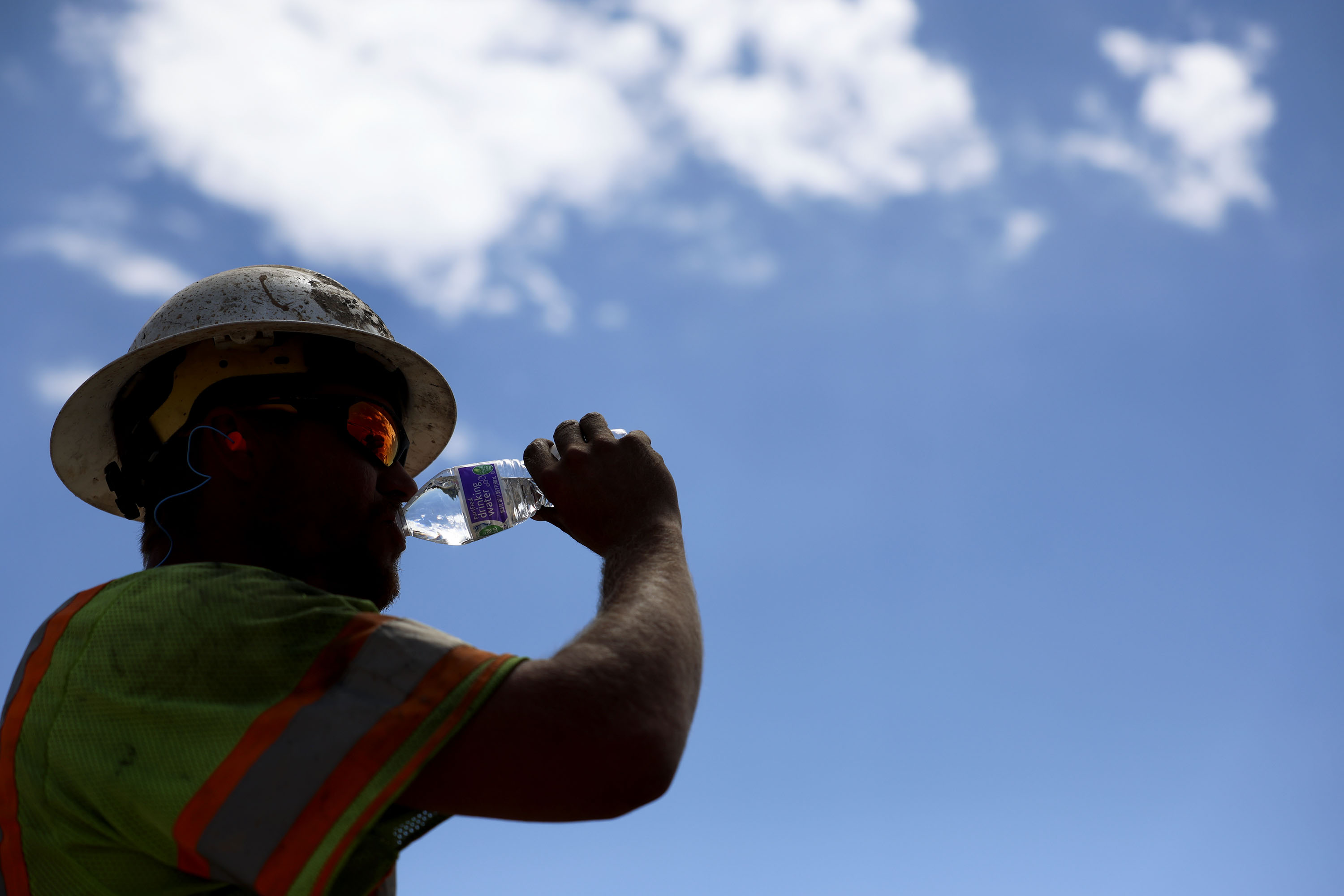 Garrett Rowser hydrates while working at a construction site in Salt Lake City on Aug. 11, 2023. Temperatures could reach as high as 104-108 degrees Fahrenheit in parts of Utah on Thursday and Friday.