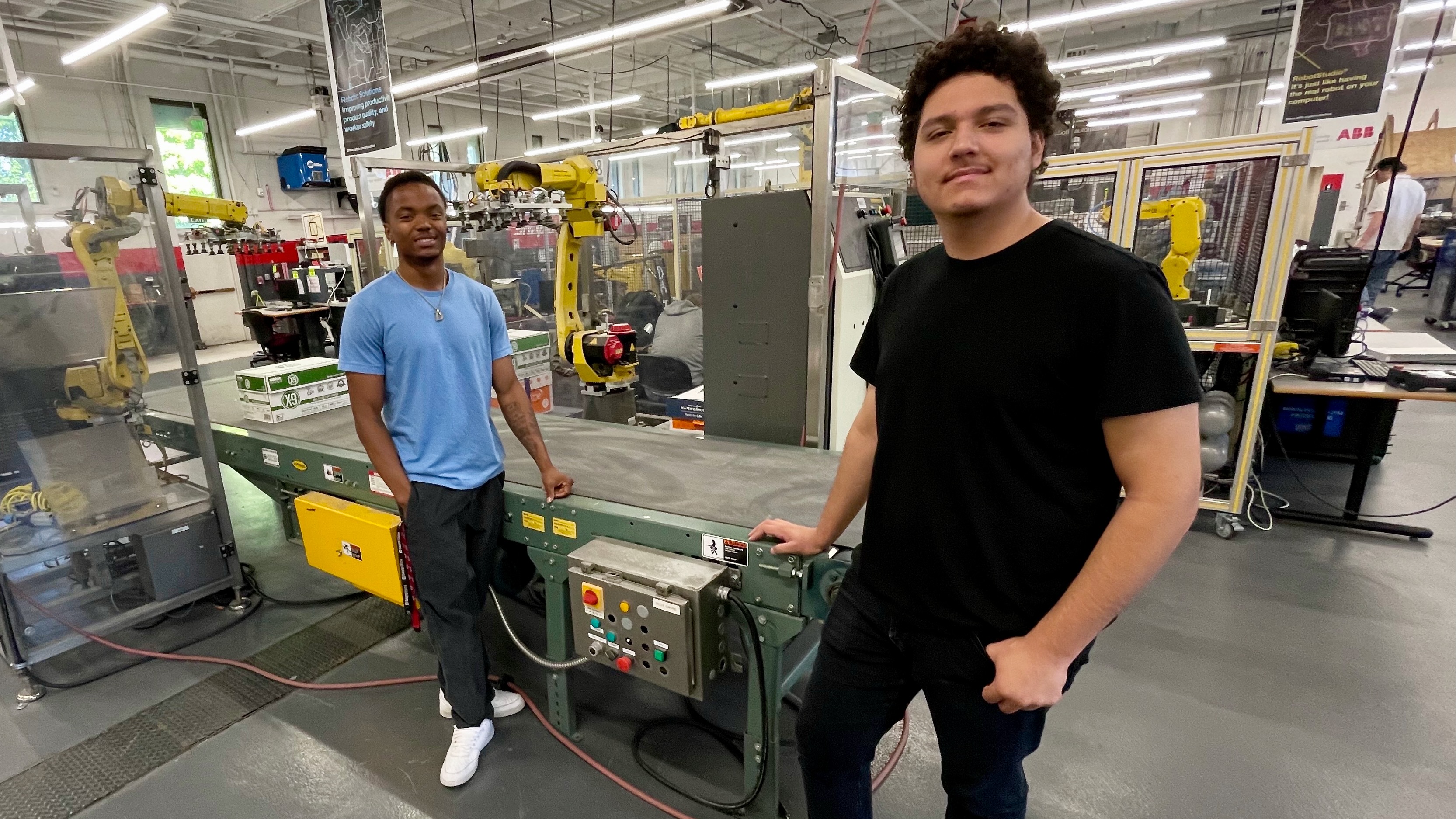 Clearfield Job Corps students Nike Reifenberger, right, and Deon Thomas at a robotics and automation classroom at Davis Technical College in Kaysville on Tuesday.